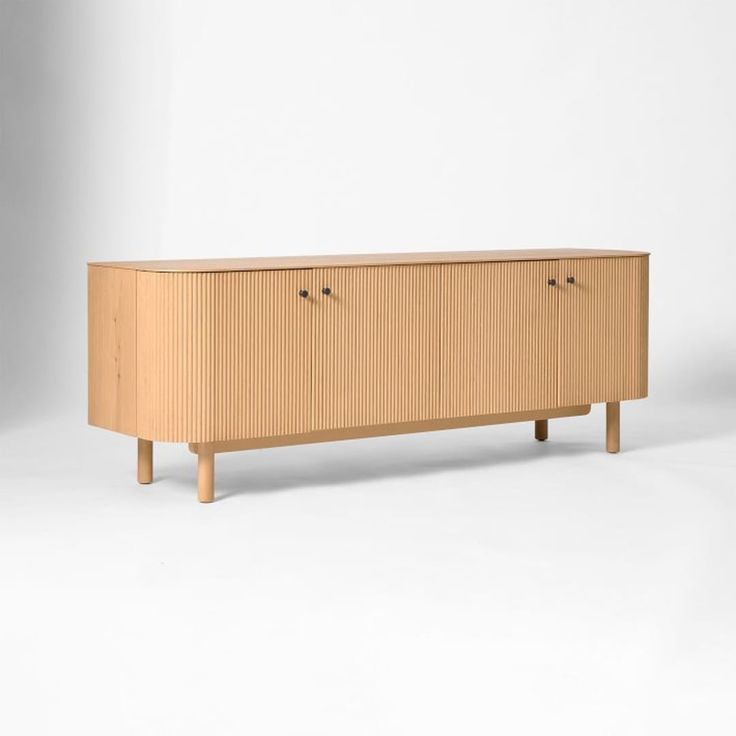 the sideboard is made out of wood and has two doors on one side, and three drawers on the other