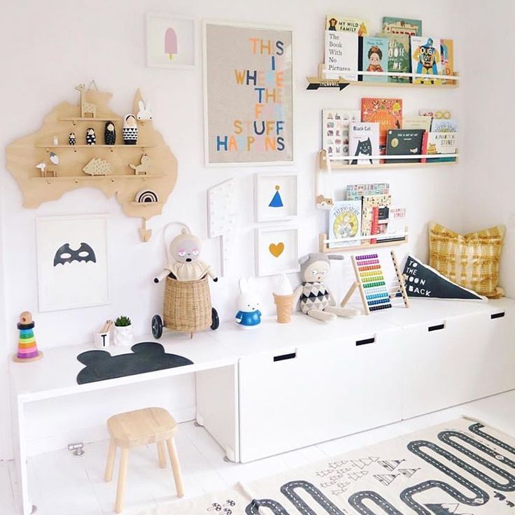 a child's playroom with toys and books on the shelves