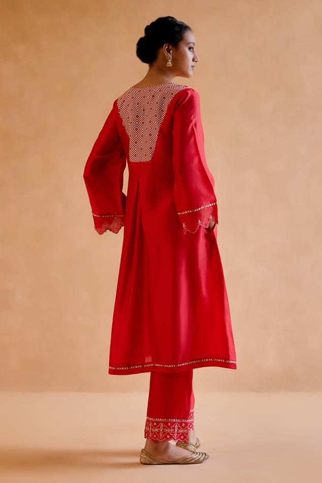 Red chanderi silk kurta featuring gold zardozi and thread embroidery on the neckline and delicate cut work on the sleeves. Paired with an embroidered pant, tribal motif tasseled dupatta and slip.
Components: 4
Pattern: Embroidered
Type Of Work: Zardosi
Neckline: V Neck
Sleeve Type: Long Cutwork
Fabric: Chanderi Silk, Silk Organza
Color: Red
Other Details: 
Kurta length: 44 inches
Model Height: 5ft 9inches, wearing size S
Occasion: Mehendi and Haldi - Aza Fashions Red Anarkali Unstitched Silk Suit, Red Anarkali Silk Unstitched Suit, Red Silk Anarkali Unstitched Suit, Red Silk Unstitched Suit With Dupatta, Red Slub Silk Unstitched Suit With Resham Embroidery, Red Cotton Silk Palazzo Set With Straight Kurta, Red Cotton Silk Unstitched Suit With Straight Kurta, Red Slub Silk Unstitched Suit For Navratri, Bollywood Style Red Slub Silk Unstitched Suit