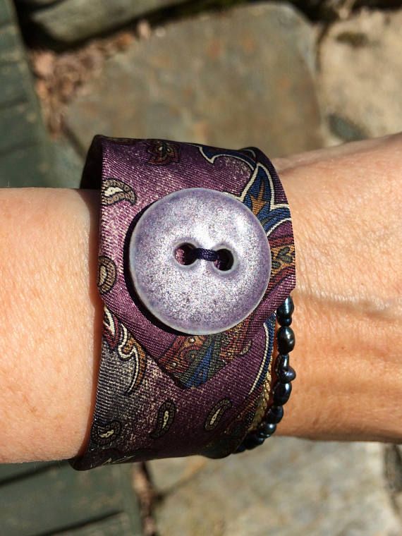 a close up of a person's arm with a bracelet on it and a button