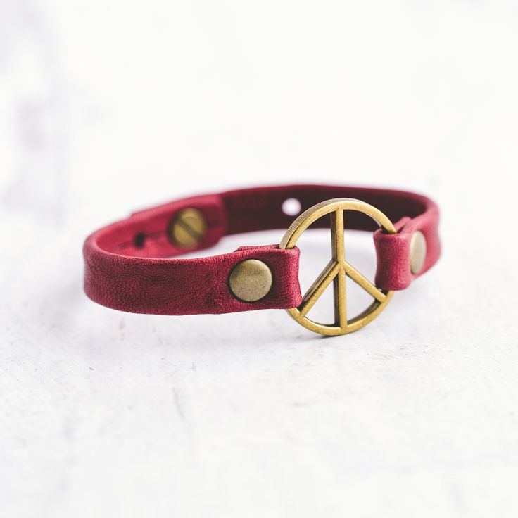 Our Peacemaker bracelet was inspired by the powerful meaning behind it. It represents taking action to reach for unity and understanding, so it's no surprise it's one of our most popular styles. Handcrafted with the softest lamb leather and detailed with antique brass flat rivets, this bracelet can be worn alone or stacked with your favorite Giving Bracelet! FEATURES Handcrafted - Each Bracelet is delicately handcrafted. Finest Leather Available - We use lamb leather to achieve a much softer fee Spiritual Leather Bracelet For Everyday, Spiritual Everyday Leather Bracelet, Adjustable Spiritual Cuff Bracelet For Friendship, Adjustable Symbolic Bangle Bracelet, Adjustable Symbolic Cuff Bracelet, Adjustable Spiritual Leather Bracelet For Friendship, Symbolic Friendship Bracelets, Symbolic Adjustable Bracelets For Festivals, Adjustable Symbolic Bracelets For Festivals