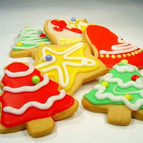 several decorated christmas cookies on a white surface