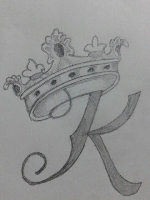 the letter k with a crown on it is drawn in graphite and pencils