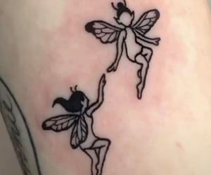 two black and white fairy tattoos on the back of a woman's thigh