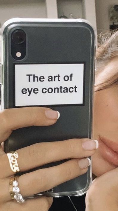 a woman is looking at her cell phone with the text'the art of eye contact'on it