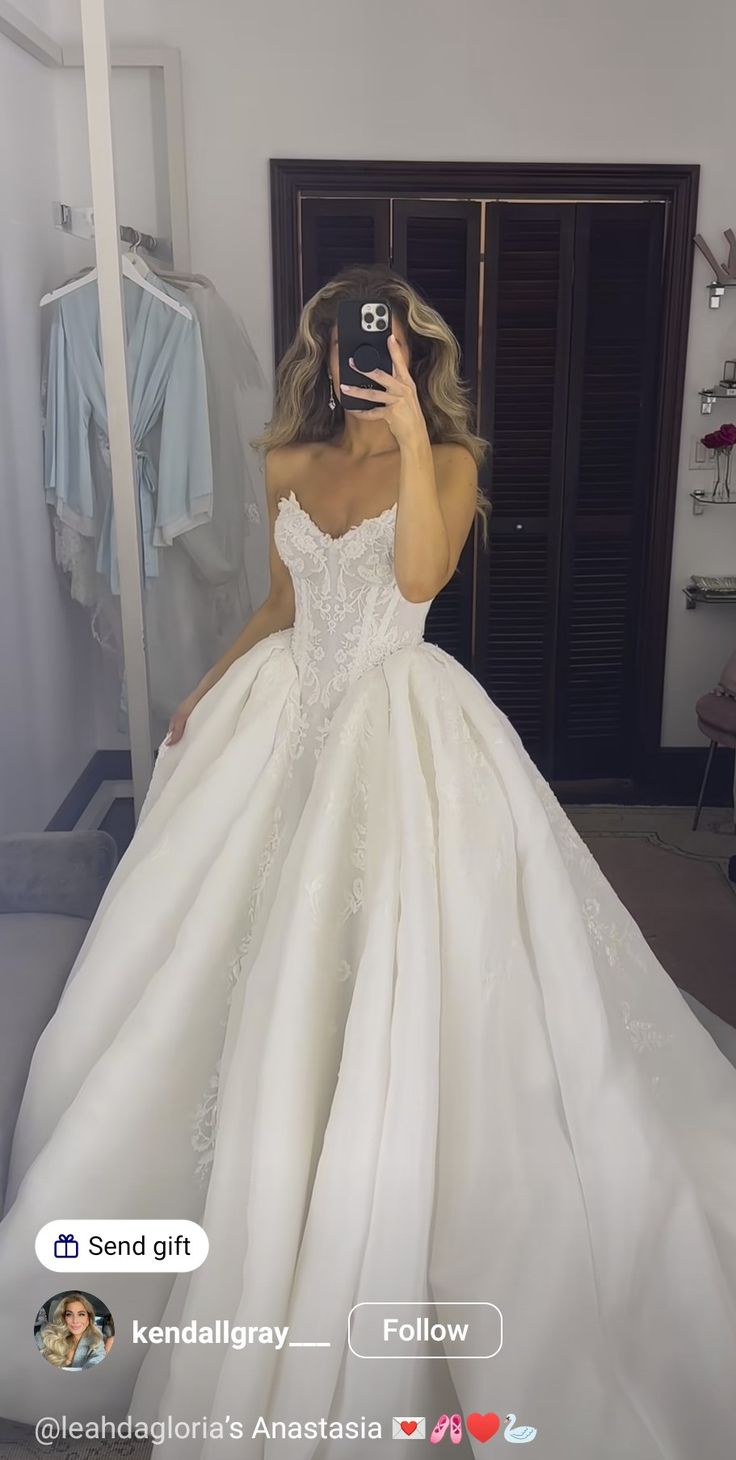 the woman is taking a selfie in her wedding dress while she takes a photo