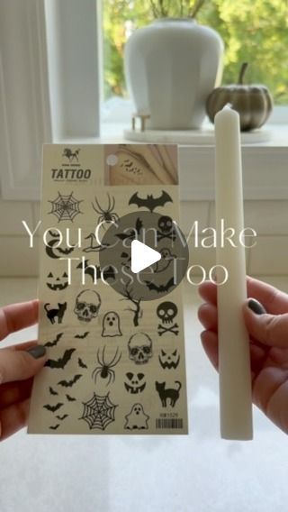 two hands holding up a card with halloween stickers on it