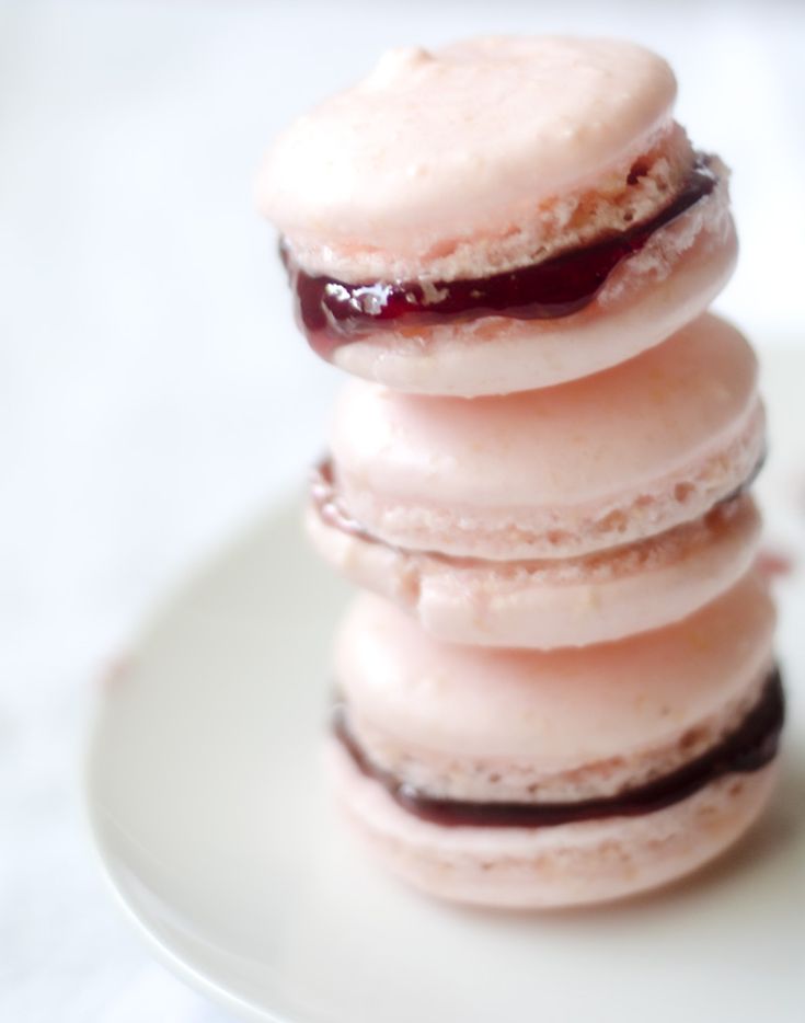 a stack of four donuts sitting on top of a white plate