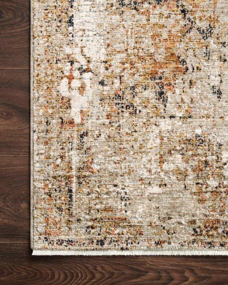 an area rug that is on top of a wooden floor, with wood floors in the background