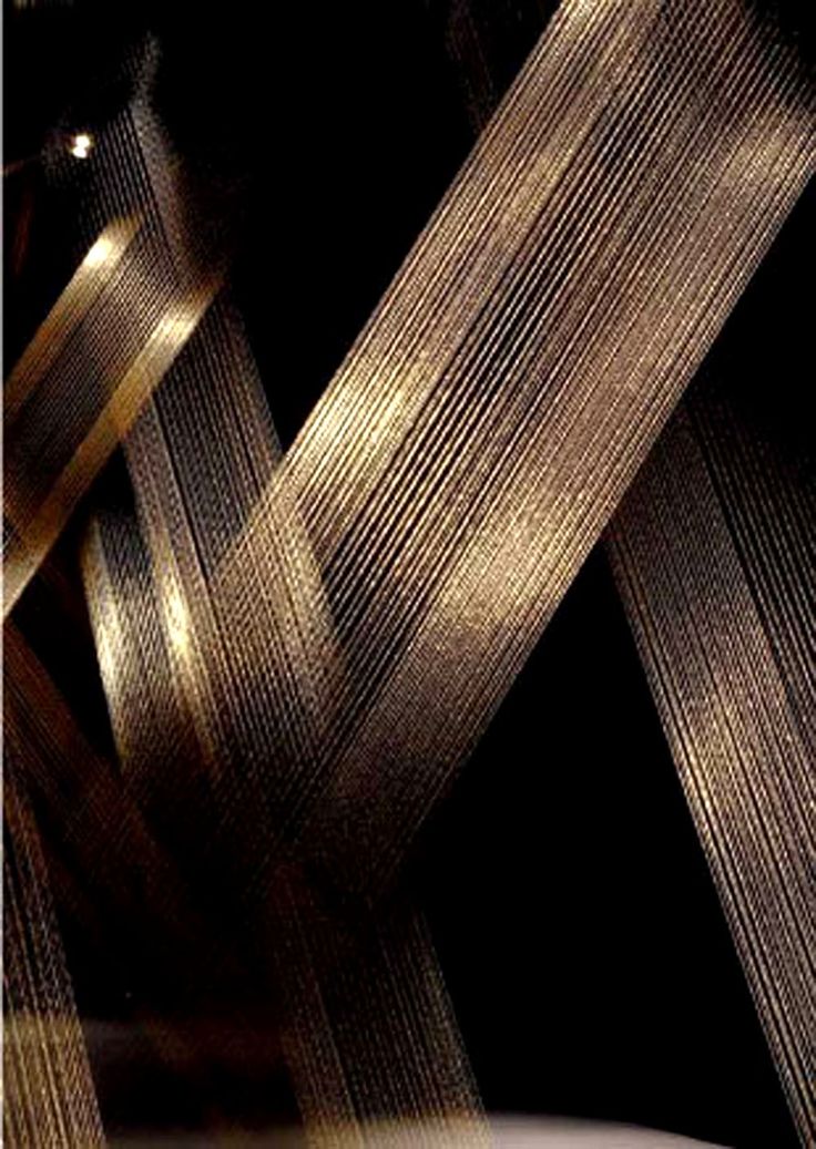 an abstract photograph of gold and black ribbons