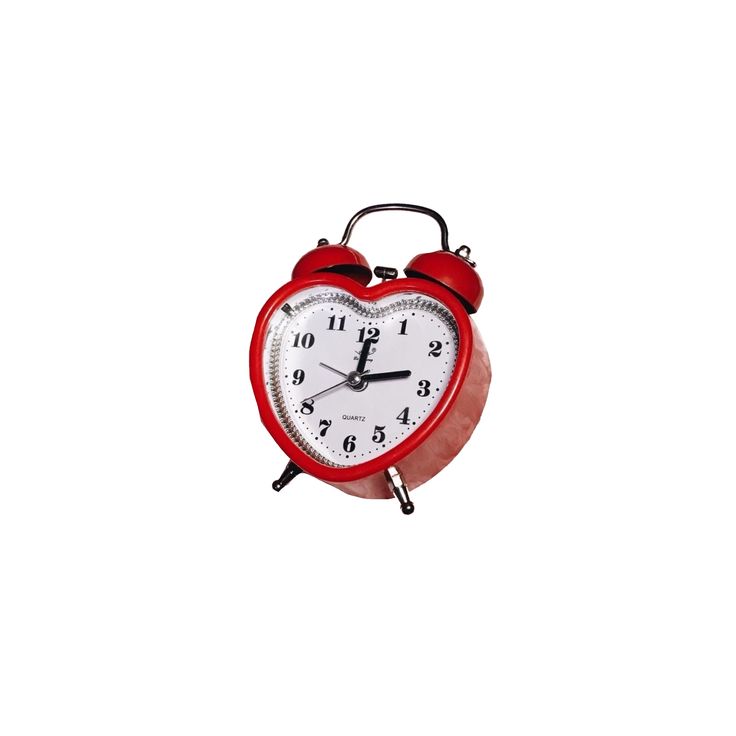 a red alarm clock sitting on top of a table