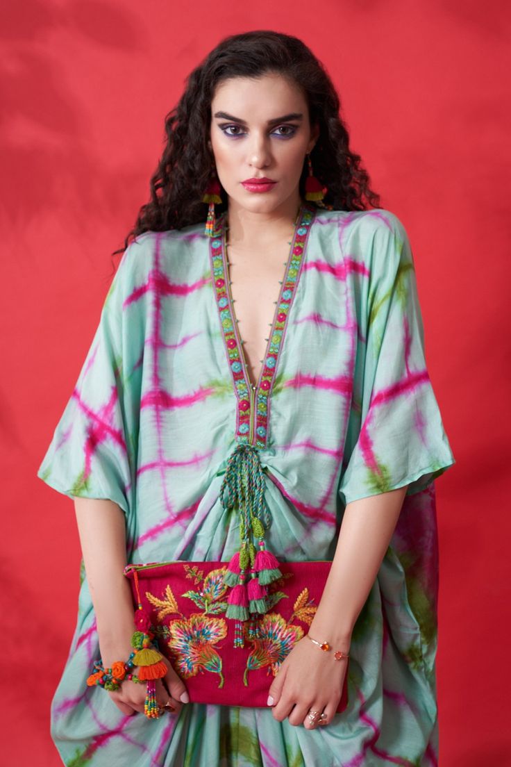 Mint, multicolor tie dye kaftan with embroidery on the neckline and tie up at the waist.
Component: 1
Pattern: Tie Dye and Embroidery
Type Of Work: Thread and Beads
Neckline: V neck
Sleeve Type: Kaftan Sleeves
Fabric: Cotton Silk
Color: Green,Multi Color
Other Details: 
Asymmetrical hem
Note: Clutch carried by the model is not for sale
Occasion: Resort - Aza Fashions Kaftan Sleeves, Tie Dye Kaftan, V Neck Kaftan, Thread Beads, Kaftan For Women, Green Thread, Beaded Neckline, Asymmetrical Hem, Green Cotton