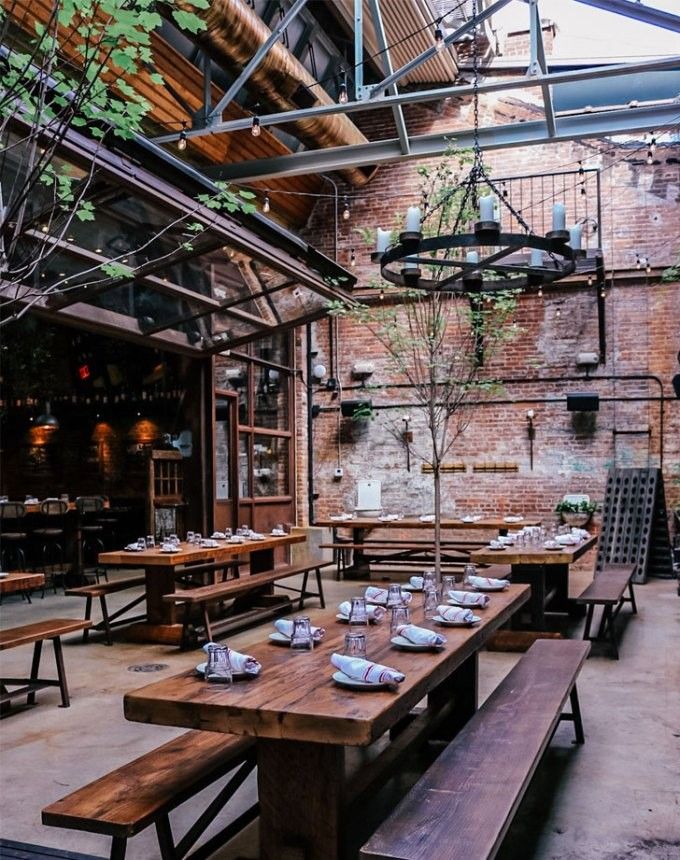 an outdoor dining area with wooden tables and benches