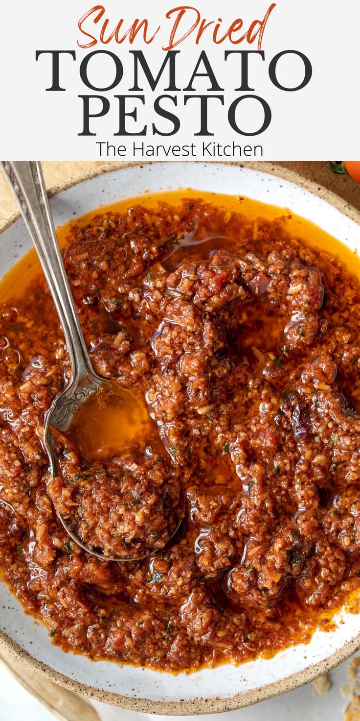 sun dried tomato pesto in a white bowl with spoon