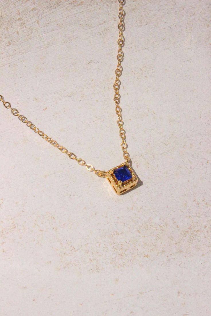 PRODUCT DESCRIPTION Chic and sophisticated, this Diane Necklace is inspired by the glamour of bygone eras. This opulent piece is crafted in 18k Gold-plated or 14k Gold-filled with metal and features a blue square-cut cubic zirconia pendant. Effortlessly elegant and pairs beautifully with day and evening ensembles. You are fine to shower in our gold-filled jewelry. Get it wet, wear it for life! A Dainty yet Elegant Necklace Water and Tarnish Resistant 14k Gold-filled with jeweler's brass (at leas Luxury Blue Square Pendant Necklace, Blue Square Pendant Jewelry For Formal Occasions, Elegant Sapphire Square Pendant Jewelry, Formal Blue Square Pendant Jewelry, Luxury Blue Square Pendant Jewelry, Elegant Square Gold Jewelry, Blue Rectangular Diamond Cut Jewelry, Gold Jewelry With Rectangular Stone For Formal Occasions, Gold Jewelry With Rectangular Stone For Formal Events