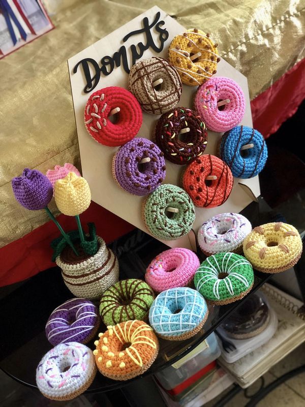 there are many crocheted donuts on display