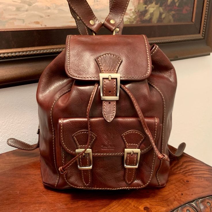 Genuine Leather Backpack By Vera Pelle, Made In Florence Italy The Genuine Italian Leather Crossbody Saddle Handbag Is Defined By It's Curved Shape And Finely Detailed Stitching. Perfect For Year-Round. Size, Large: 12” X 14 1/2” Adjustable Leather Straps Luxury Brown School Bag, Luxury Backpack With Leather Handles For Daily Use, Elegant Brown Leather Backpack For School, Designer Everyday Backpack With Leather Handles, Designer Backpack With Leather Handles For Everyday, Designer Leather Shoulder Backpack, Designer Brown Backpack For School, Luxury Brown Backpack For School, Luxury Brown School Backpack