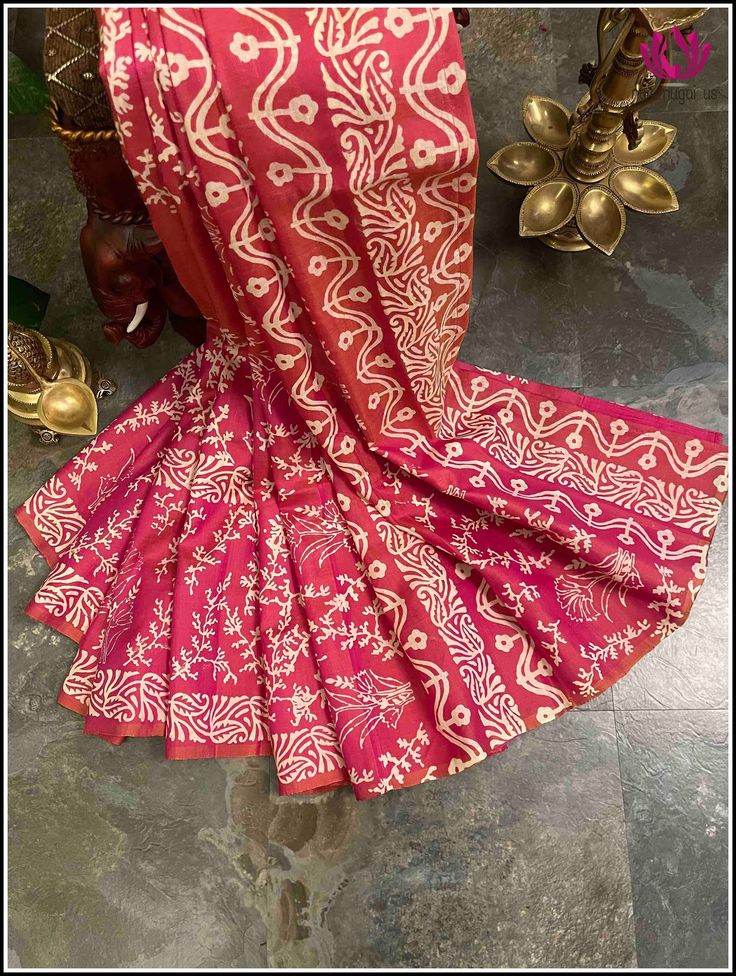 Drape yourself in elegance with this beautiful Bishnupuri Katan Silk Saree. Crafted with lightweight silk and featuring a beautiful pink shade, it has a versatile style perfect for evening parties and casual wear. Its hand block printed, floral hand block prints and elegant design make it the perfect choice for any occasion. Certified by Silk Mark, this saree is sure to make a lasting impression.  Slay that party with this statement saree. 👉Styling tip: Accessorize with german silver jewelry for a super trendy look. 👉Fall and Pico - done 👉Blouse - unstitched 👉Hand block printed saree. Silk mark certified saree. Please note: 👉Color may vary slightly from the picture. 👉Thread pulls, knots and few thread gaps are common in this type of saree and is not a defect. 👉Mild paint stains are Bollywood Style Batik Print Saree For Diwali, Red Chanderi Blouse Piece With Block Print, Traditional Art Silk Saree With Batik Print, Red Blouse Piece With Block Print For Puja, Red Block Print Blouse Piece For Diwali, Diwali Batik Print Saree In Traditional Drape, Red Block Print Blouse Piece For Puja, Pink Anarkali Traditional Wear With Block Print, Traditional Drape Saree With Batik Print For Diwali