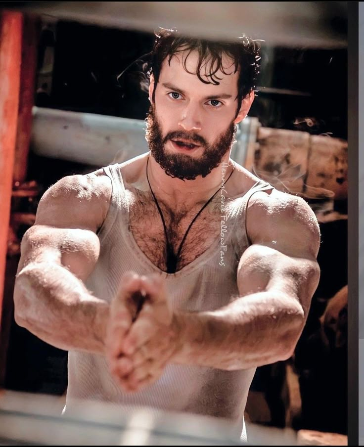 a man with his arms stretched out in front of the camera, making a fist gesture