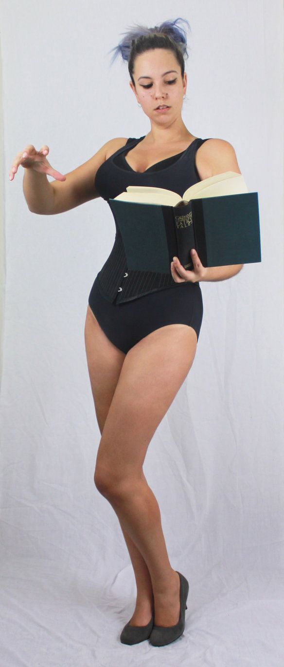 a woman in a bodysuit is holding a book