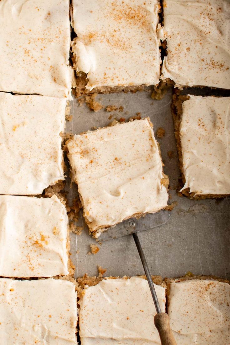 several pieces of cake sitting on top of a sheet of baking paper next to a spatula