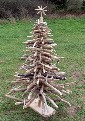 a wooden christmas tree made out of sticks