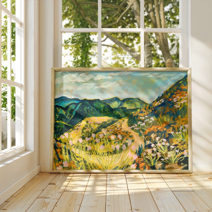 an empty room with a large painting on the wall and wooden flooring in front of it