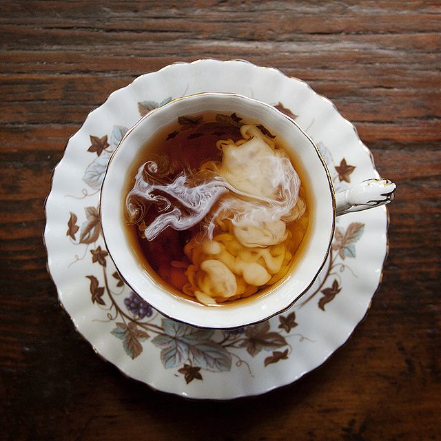 a bowl filled with soup sitting on top of a wooden table