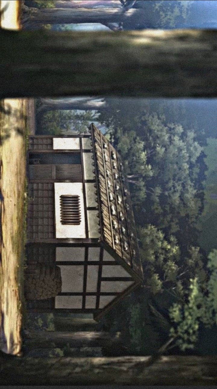 an aerial view of a building in the woods