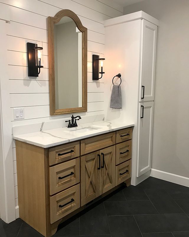 a bathroom with two sinks and a large mirror