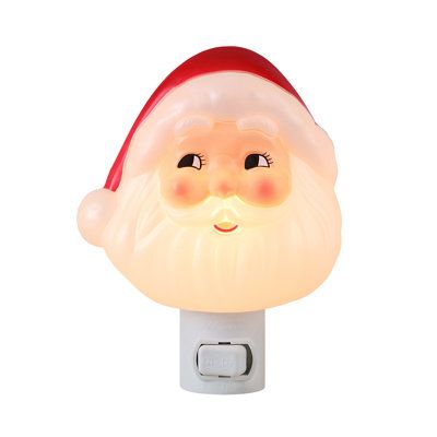 a light up santa claus head on a white wall mounted night light with red cap