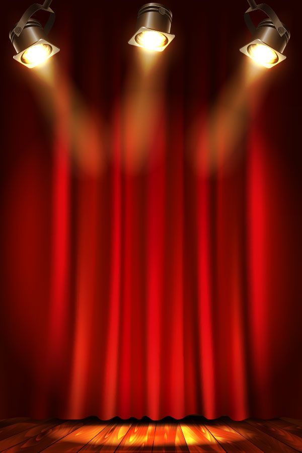 an empty stage with red curtains and three spotlights