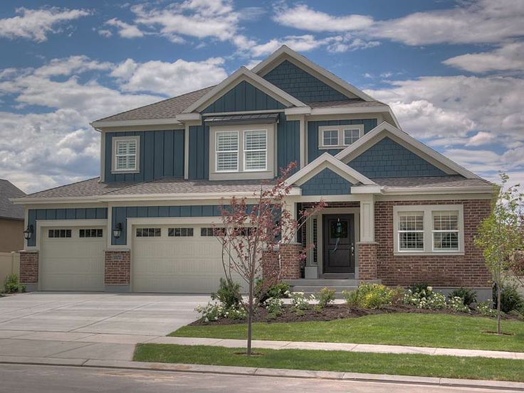 a two story house with blue siding and white trim