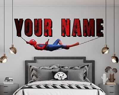 a bedroom with a spiderman wall decal on the wall