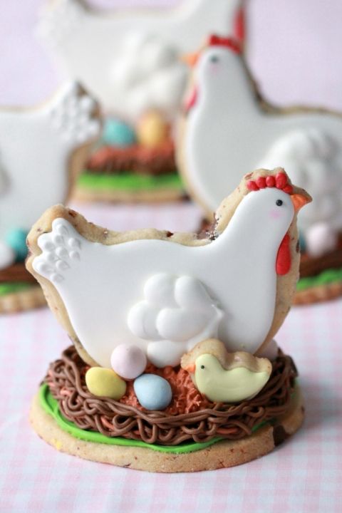 decorated cookies in the shape of chickens and eggs