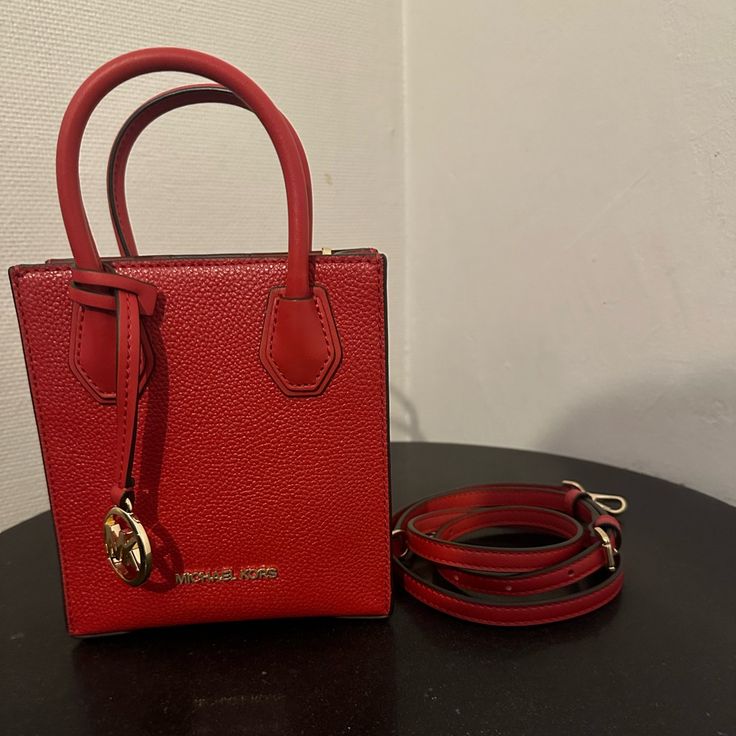 Never Used Michael Kors Handbag With Crossbody Strap Square Bags With Branded Hardware, Designer Red Box Bag With Handles, Square Bags With Gold-tone Hardware For Shopping, Red Box Bag With Handles For Travel, Luxury Red Box Bag For Shopping, Designer Red Satchel Box Bag, Red Square Box Bag With Top Carry Handle, Red Square Box Bag With Top Handle, Luxury Red Crossbody Box Bag