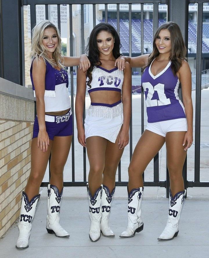 three women in purple and white outfits standing next to each other with cowboy boots on