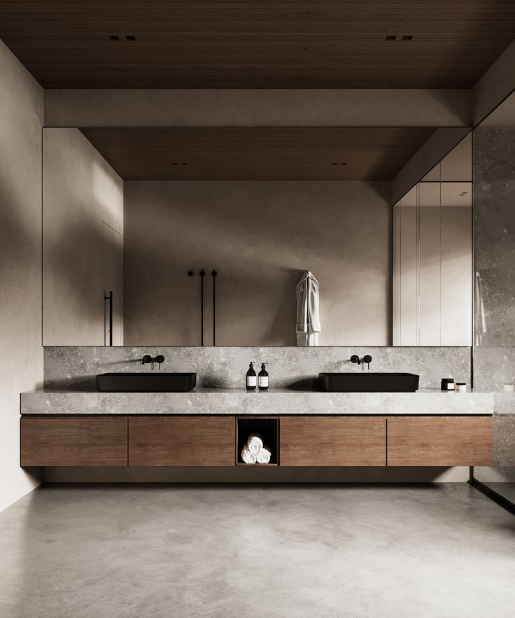 a large bathroom with two sinks and mirrors