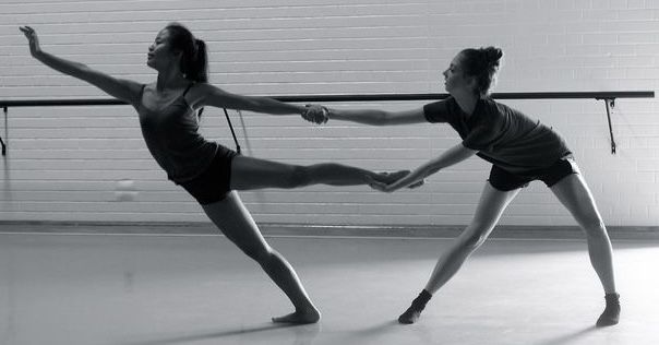 two young women are practicing ballet moves in an empty dance studio, black and white photo