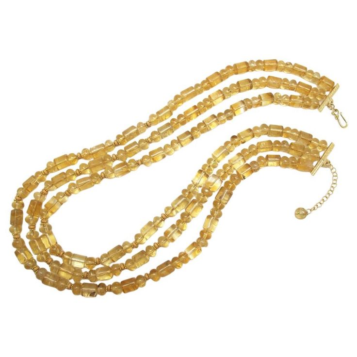 This necklace is so pretty and unusual - and the neutral color goes with everything! It features 3 strands of highly transparent, golden citrine beads of various sizes and shapes, hand-strung with 14k and 18k yellow gold rondelle spacers for extra sparkle. Make this flattering golden necklace your signature piece! Necklaces measure 18.5, 19.5 and 20.5 inches in length Elegant Amber Crystal Necklaces With Polished Beads, Elegant Amber Necklace With Gold Beads, Elegant Gold Crystal Necklace With Polished Beads, Elegant Faceted Amber Crystal Necklaces, Elegant Faceted Amber Crystal Necklace, Elegant Amber Faceted Crystal Necklace, Gold Double Strand Crystal Necklace With Faceted Beads, Gold Multi-strand Necklace With Faceted Beads, Elegant Multi-strand Amber Necklace