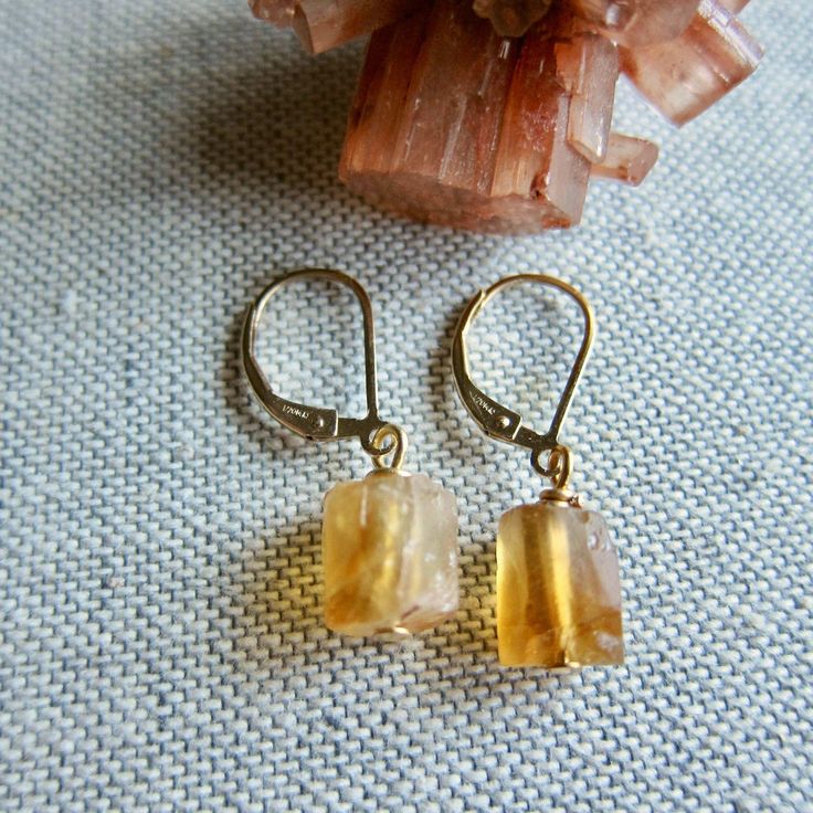 ★Metal- Gold Fill Ear Wires ★Stone- Genuine Raw Citrine ★ 1.2 inches long ★We want you to love your new jewelry and gladly accept returns. ★Arrives ready for gifting (example in last photo) and usually ships same day or next day. Check shop announcement for occasional delays. Gorgeous raw citrine in all it's warm, sunny beauty hang from high quality gold fill lever backs ear wires. Each pair is unique and ready to gift to that someone special. Citrine is the birthstone for November. ✧Metaphysica Citrine Drop Earrings With Ear Wire, Citrine Dangle Earrings With Ear Wire, Amber Citrine Drop Earrings, Nickel-free Citrine Dangle Jewelry, Amber Dangle Earrings With Lever Back, Citrine Dangle Earrings For Pierced Ears, Amber Dangle Earrings With Ear Wire, Amber Dangle Earrings As Gift, Amber Dangle Earrings For Gift