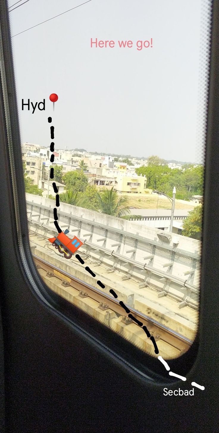 the view from inside an airplane looking out at a train track with a red car on it