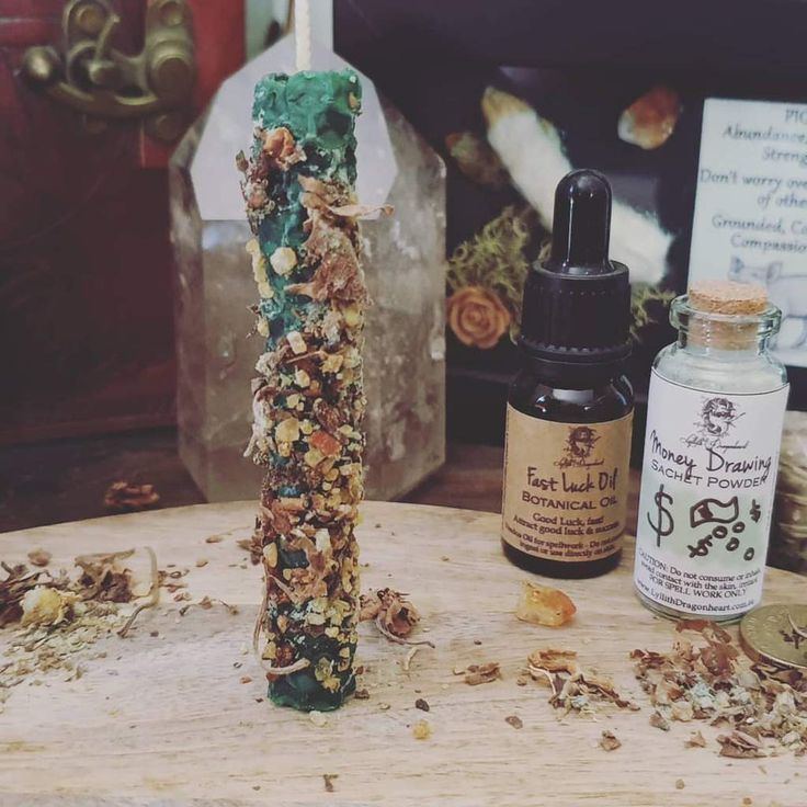 a wooden table topped with lots of different types of items next to a bottle of essential oils