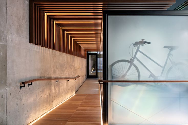 a bike is reflected in the glass wall