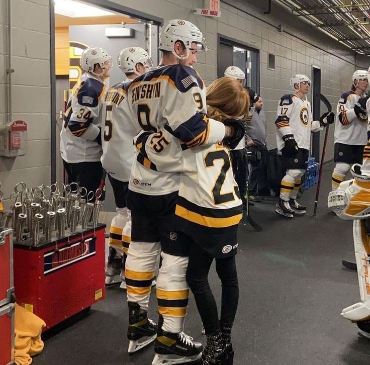 the hockey players are congratulating each other in the locker room at the game