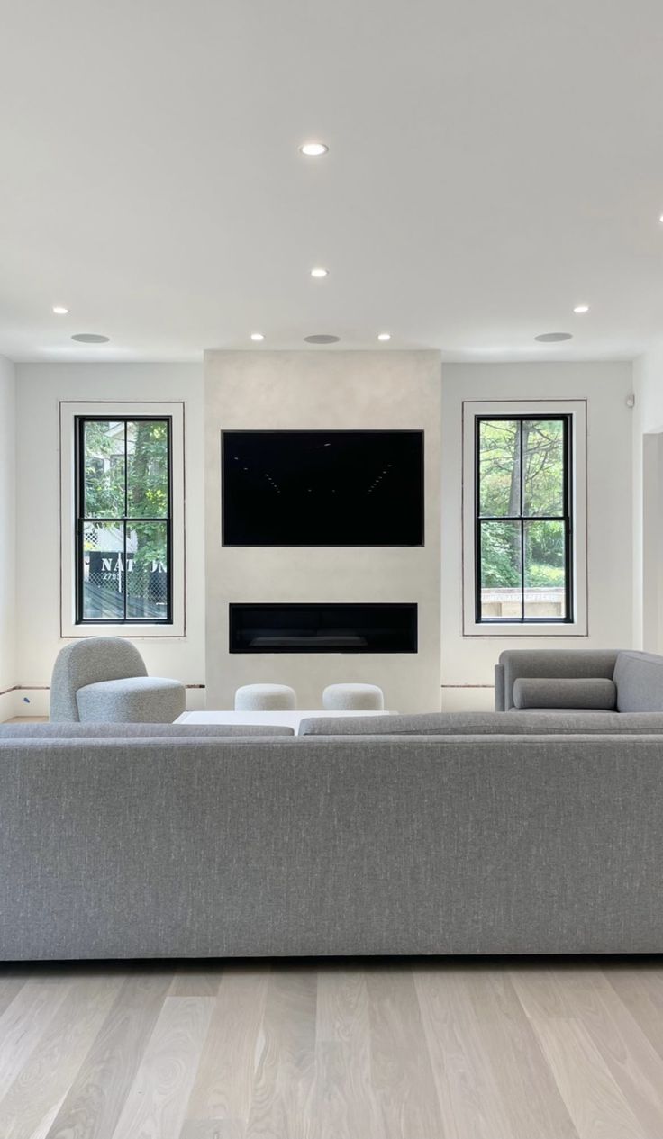 a living room filled with furniture and windows