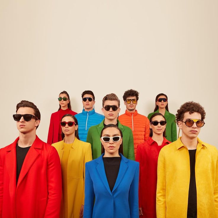 a group of men and women in colorful clothing standing next to each other with sunglasses on