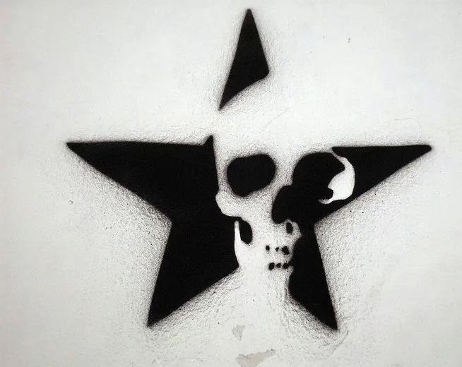 a black and white photo of a star with a skull on it's side