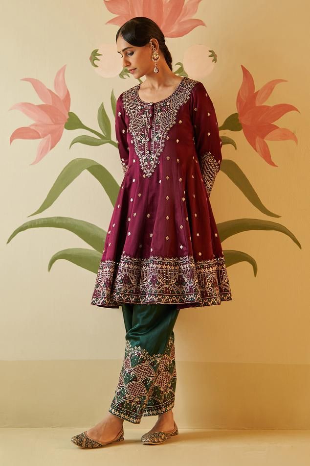 Wine anarkali with floral gotta, silken threads and mirror work, zari embroidery. Paired with embroidered pant and embroidered dupatta.
Components: 3
Pattern: Embroidered
Type Of Work: Floral
Neckline: Round
Sleeve Type: Three quarter
Fabric: Silk, Lining: Crepe
Color: Wine
Other Details: 
Attached lining
Scallop border dupatta
Note: All the jewellery worn by the model is for styling purpose only
Occasion: Wedding - Aza Fashions Embroidered Jamawar Anarkali Set, Traditional Jamawar Anarkali Set For Reception, Reception Jamawar Churidar With Dabka Work, Jamawar Churidar With Dabka Work For Reception, Festive Jamawar Churidar With Gota Work, Navratri Sharara With Mirror Work And Jamawar Fabric, Navratri Jamawar Sharara With Mirror Work, Bollywood Style Jamawar Sharara With Gota Work, Bollywood Style Sharara With Gota Work In Jamawar