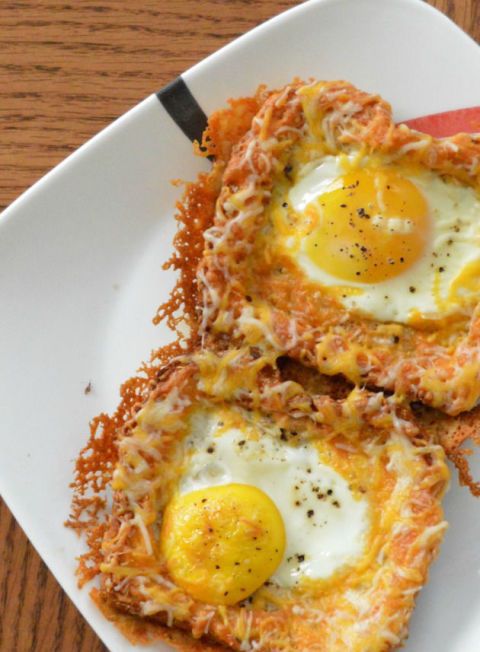 two fried eggs are on top of some hashbrowns with grated parmesan cheese